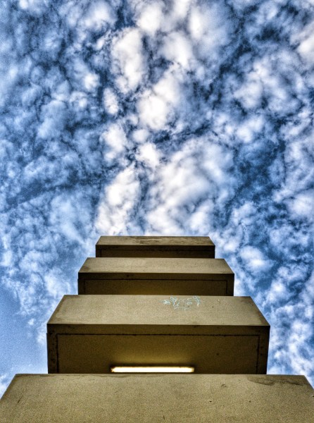 building with fluffy clouds